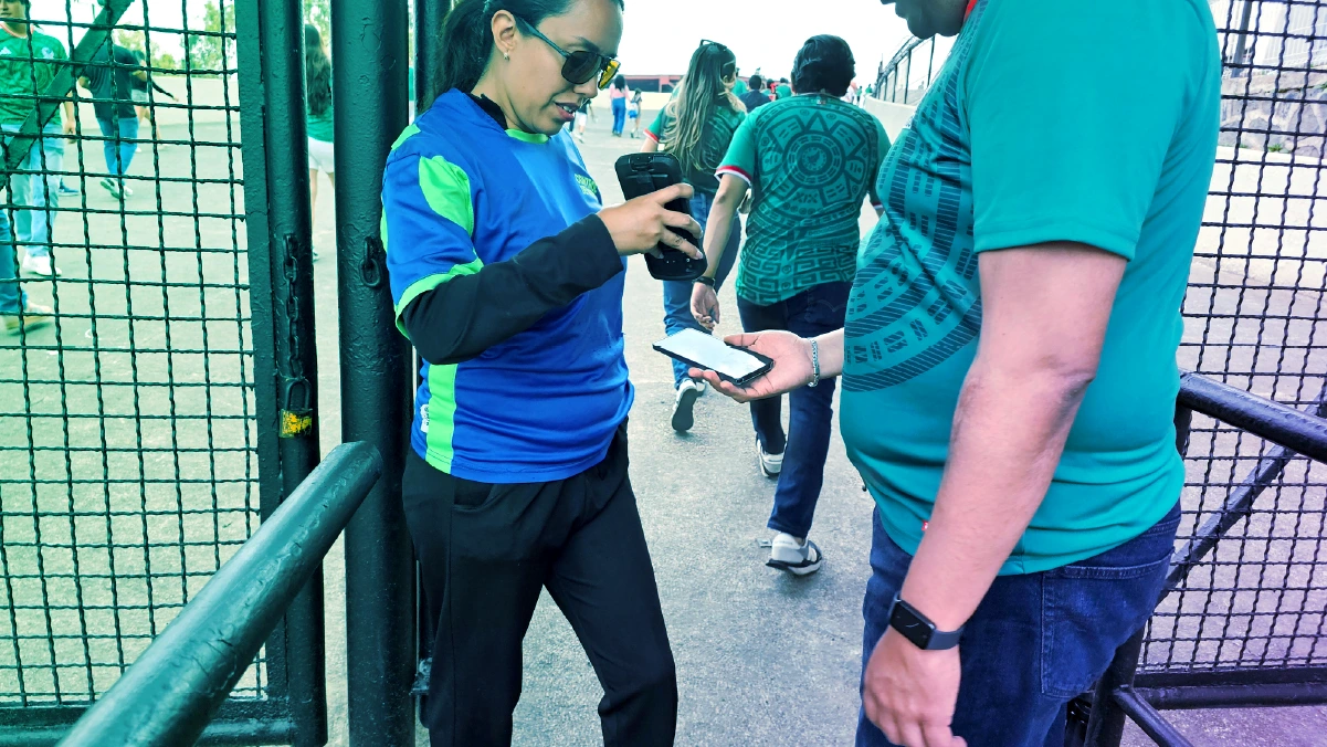 event worker scanning ticket outside of gate