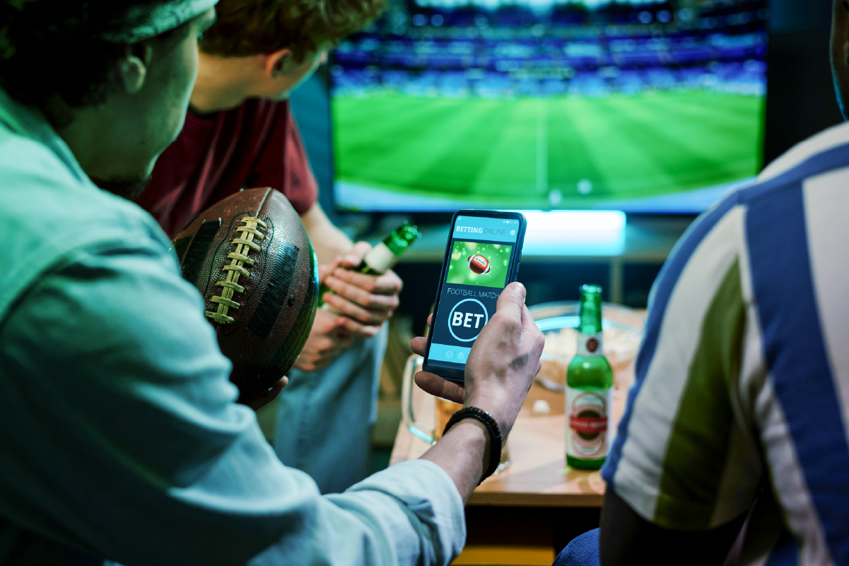 people watching sports holidng a phone